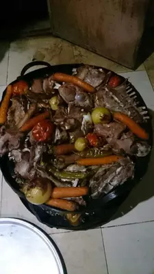 a bowl of meat and vegetables on a table at Climbers House in Wadi Rum in Wadi Rum