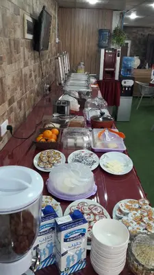 a long table with plates of food on it at Beirut Hotel 1 in Amman
