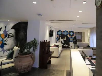 a store with paintings on the walls of a room at La Locanda Boutique Hotel in Amman