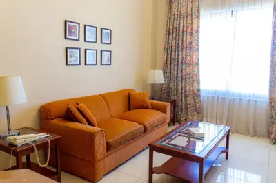 a living room with a couch and a table at Comfort Hotel Suites in Amman