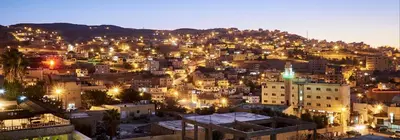 a view of a city at night at Petra Gate Hotel in Wadi Musa
