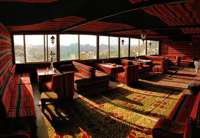 a room with benches and windows in a building at Petra Gate Hotel in Wadi Musa