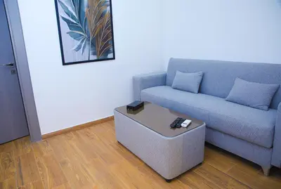 a living room with a couch and a coffee table at Spark Plaza Hotel in Amman