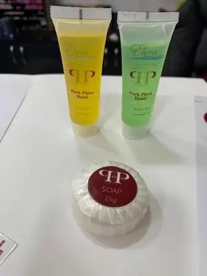 a table with two bottles of lip sunscreen and a disc at Spark Plaza Hotel in Amman
