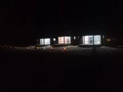 a building at night with lights in the dark at Joy to Wadi Rum in Wadi Rum