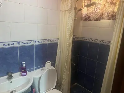 a bathroom with a toilet and a sink and a shower at Al-Amer Aqaba Beach Hostel in Aqaba