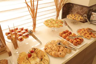 a buffet filled with different types of pastries and desserts at Lacosta Hotel in Aqaba
