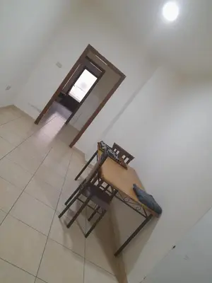 a chair sitting on a tiled floor in a room at Al Karawan Hotel Apartments in Amman