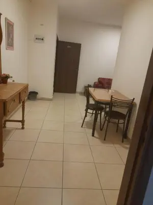 a room with a table and a table and chairs at Al Karawan Hotel Apartments in Amman