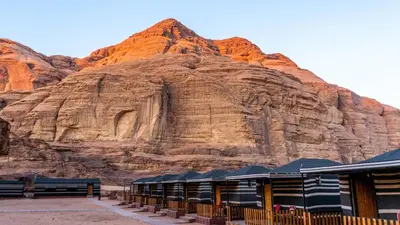 a building in front of a large rock formation at Salman Zwaidh Camp in Wadi Rum