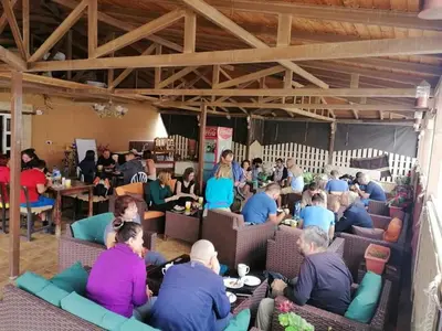 a group of people sitting in chairs in a room at Madaba Hotel in Madaba
