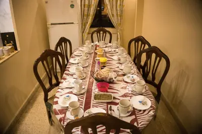 a long table with plates and cups on it at Madaba Hotel in Madaba