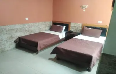 a room with two beds in a room at Amman Palace Hotel in Amman