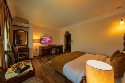 a hotel room with a bed and a television at Town Season Hotel in Wadi Musa
