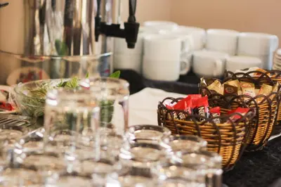 a table with baskets and glasses on a table at Capri Hotel Suites in Amman