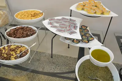 a table with several trays of different types of food at Capri Hotel Suites in Amman