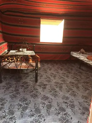 a room with two beds and a window in it at Bedouin House Camp in Wadi Rum