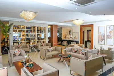 a lobby with couches and tables in a room at Lijam Hotel in Amman