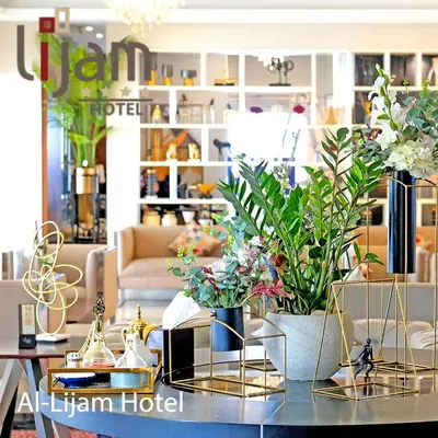 a store with two vases with plants on a table at Lijam Hotel in Amman