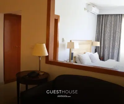 a hotel room with a bed and a mirror at Guest House Hotel Amman by FHM in Amman