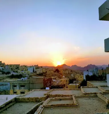 a view of a city with the sunset in the background at Orient Gate in Wadi Musa