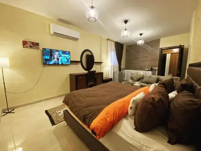 a bedroom with a bed with a dog laying on it at Anbat Midtown Hotel in Wadi Musa