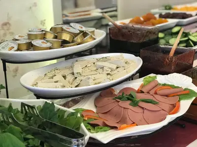 a buffet with several plates of food on a table at Virginia Hotel in Amman