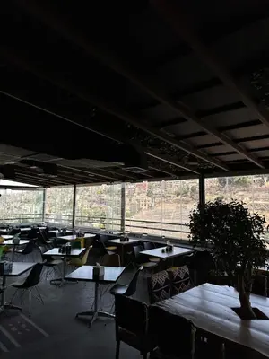 a room with tables and chairs and a large window at Amman Pasha Hotel in Amman
