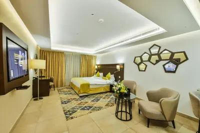 a hotel room with a bed and a table and chairs at Downtown Hotel Apartments in Amman