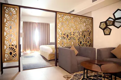 a living room with a couch and a bedroom at Downtown Hotel Apartments in Amman