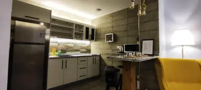 a kitchen with white cabinets and a yellow refrigerator at The Boutique Hotel Amman in Amman