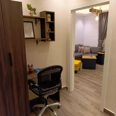 a room with a chair and a living room at The Boutique Hotel Amman in Amman
