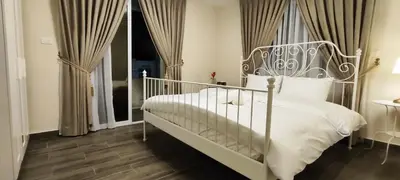 a bedroom with a white bed and a window at The Boutique Hotel Amman in Amman