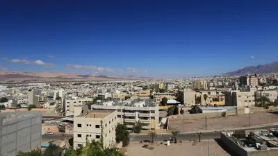 a view of a city with buildings and mountains at Weekend Hotel in Aqaba