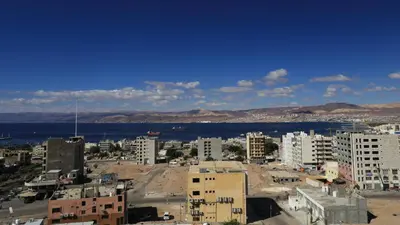 a view of a city with the ocean and buildings at Weekend Hotel in Aqaba
