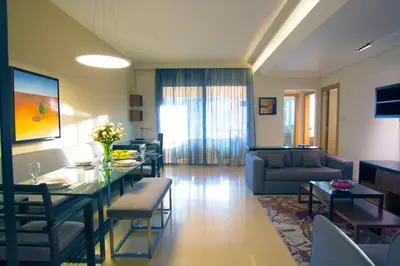 a living room with a table and a couch at Burda 41 Hotel & Suites in Amman