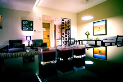 a living room with wine glasses on a table at Burda 41 Hotel & Suites in Amman