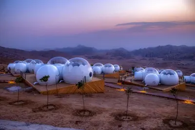 a group of white domes in the desert at Petra Bubble Luxotel in Wadi Musa