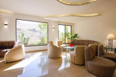 a living room with chairs and a table at Petra Palace Hotel in Wadi Musa