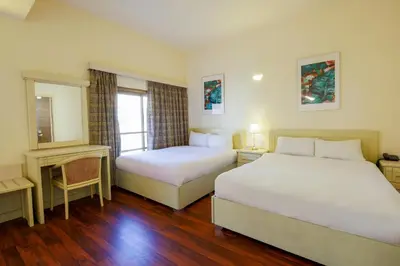 a hotel room with two beds and a window at Petra Palace Hotel in Wadi Musa