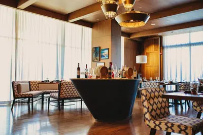 a bar in a restaurant with chairs and tables at Hyatt Regency Aqaba Ayla Resort in Aqaba