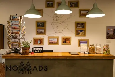 a counter at a hotel with two pendant lights at Nomads Hotel in Amman