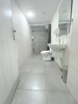 a small bathroom with a toilet and a sink at Nomads Hotel in Amman