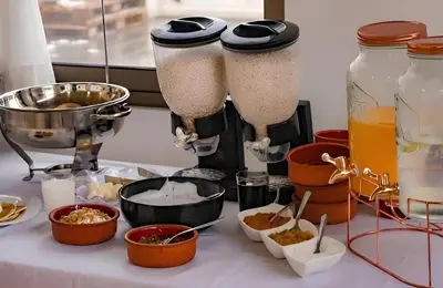 a table topped with containers of food and a blender at Nomads Hotel in Amman