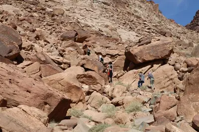 a group of people walking on a rocky mountain at Bedouin Expedition in Wadi Rum