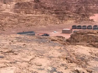 a view of a desert with a rocky mountain at Bedouin Expedition in Wadi Rum