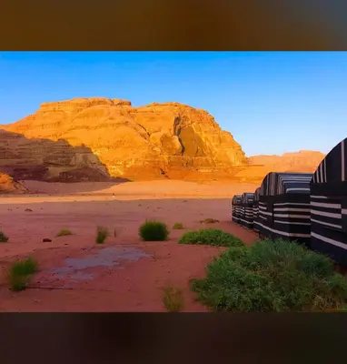 a group of benches in the desert with mountains at Bedouin Holidays Camp and Jeep Tours in Wadi Rum