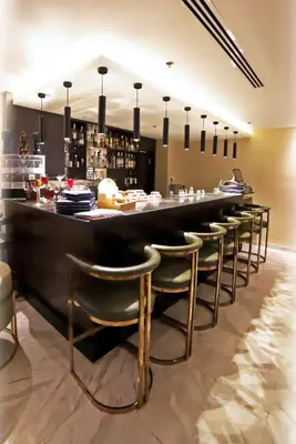a bar with a row of bar stools at The SanRock Hotel in Amman