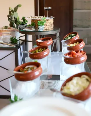 a buffet of food on a table with bowls of food at The SanRock Hotel in Amman