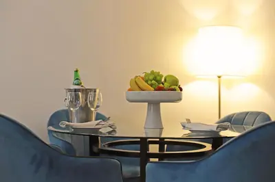 a table with a bowl of fruit on top of it at The SanRock Hotel in Amman